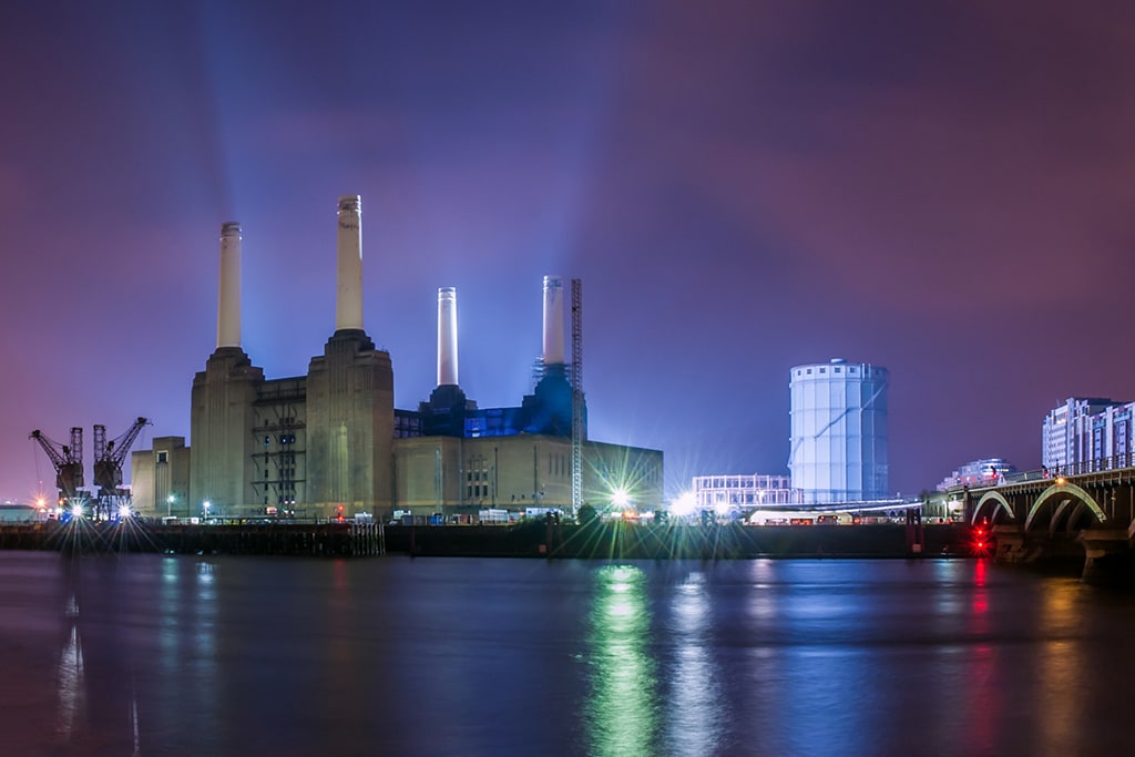 Battersea Power Station illuminated beside the Thames