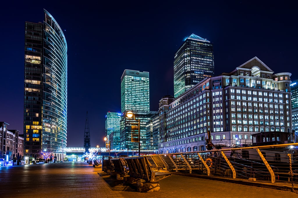 Canary Wharf buildings and riverside walkway at night