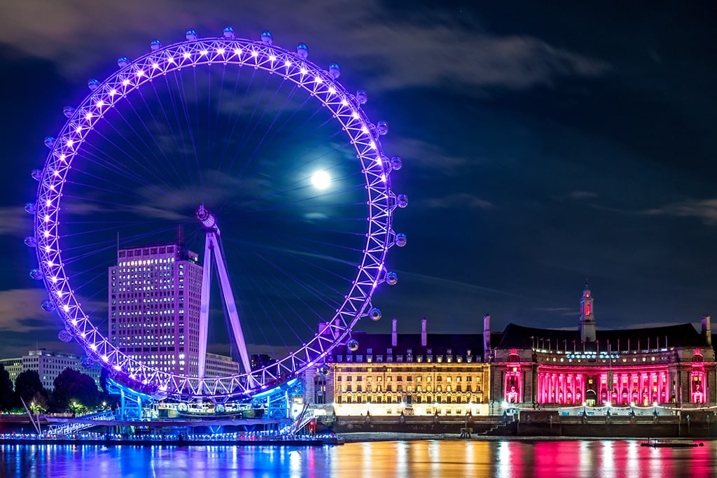 The London Eye illuminated purple at night