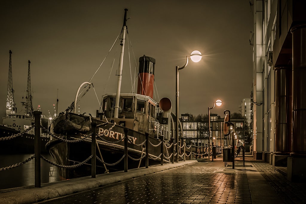 The Portwey moored beneath dockside lights